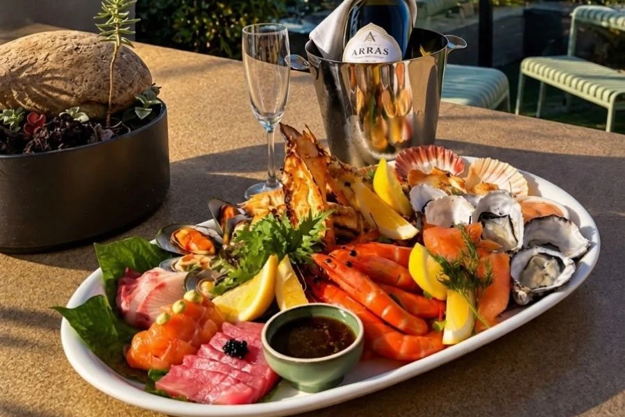 Christmas Eve seafood platter with oysters, prawns and sashimi beside a bottle of Arras sparkling wine at The Ternary, Darling Harbour